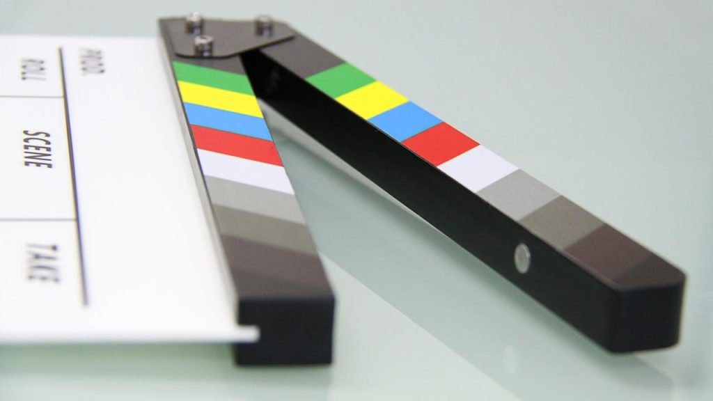white-and-black-clapper-board-274937 Colorful clapper board on a white surface, used in filmmaking. Ideal for entertainment and movie themes.